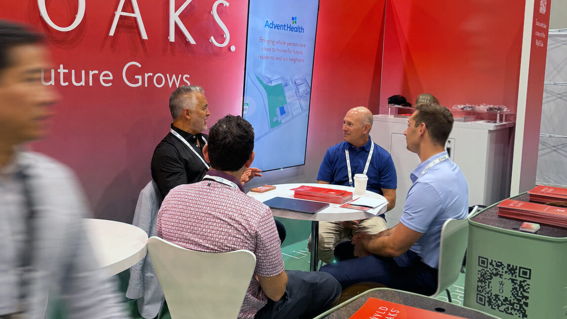 The Wyld Oaks booth at ICSC@Florida 2026, showing a meeting between several people sitting at a table surrounded by Wyld Oaks signage.