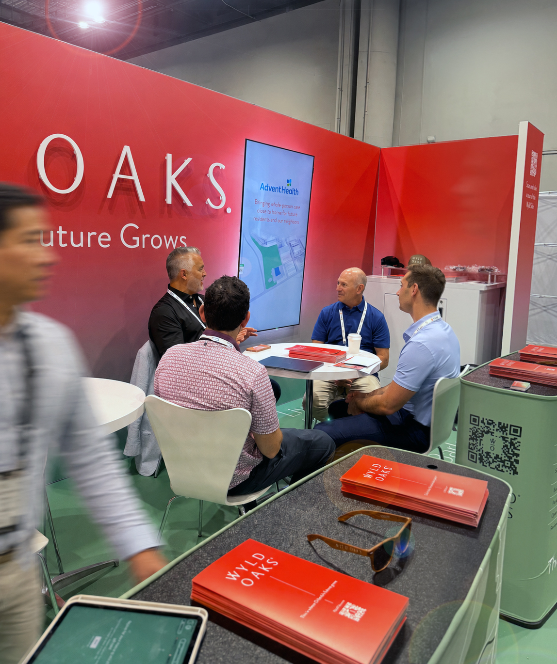 The Wyld Oaks booth at ICSC@Florida 2026, showing a meeting between several people sitting at a table surrounded by Wyld Oaks signage.